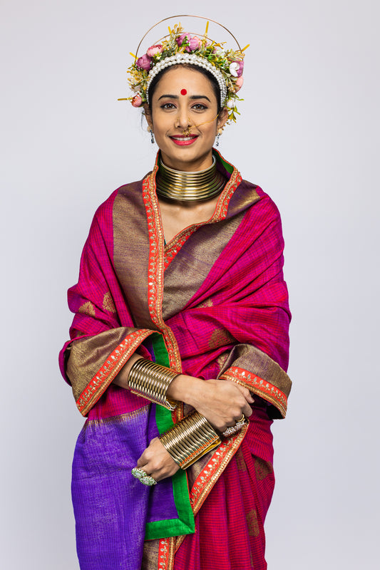 A woman wearing a beautiful handwoven benarsi silk saree designed by designer Ayush Kejriwal.