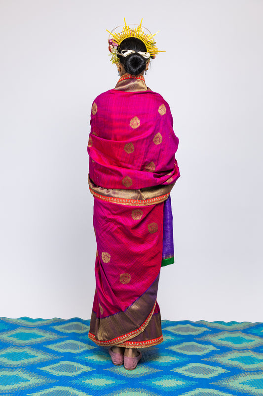 A woman wearing a beautiful handwoven benarsi silk saree designed by designer Ayush Kejriwal.