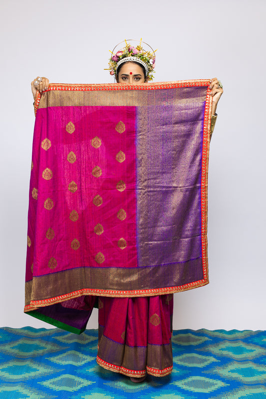 A woman wearing a beautiful handwoven benarsi silk saree designed by designer Ayush Kejriwal.