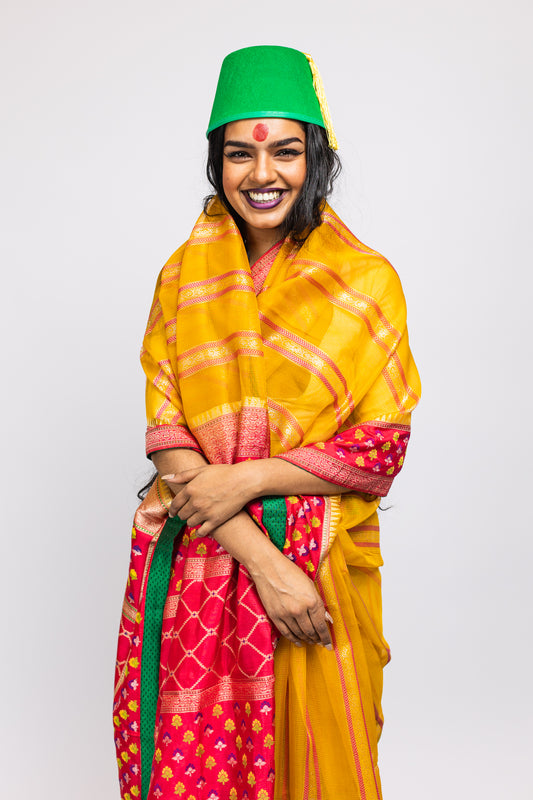 A woman wearing a yellow handwoven Cora benarsi silk saree designed by Ayush Kejriwal.