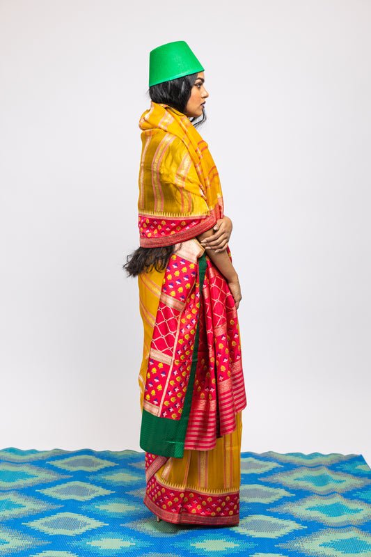 A woman wearing a yellow handwoven Cora benarsi silk saree designed by Ayush Kejriwal.