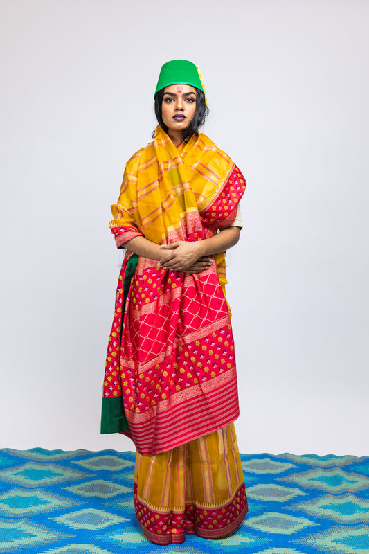 A woman wearing a yellow handwoven Cora benarsi silk saree designed by Ayush Kejriwal.