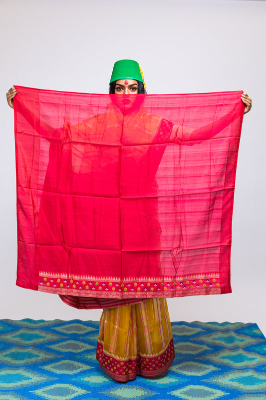 A woman wearing a yellow handwoven Cora benarsi silk saree designed by Ayush Kejriwal.