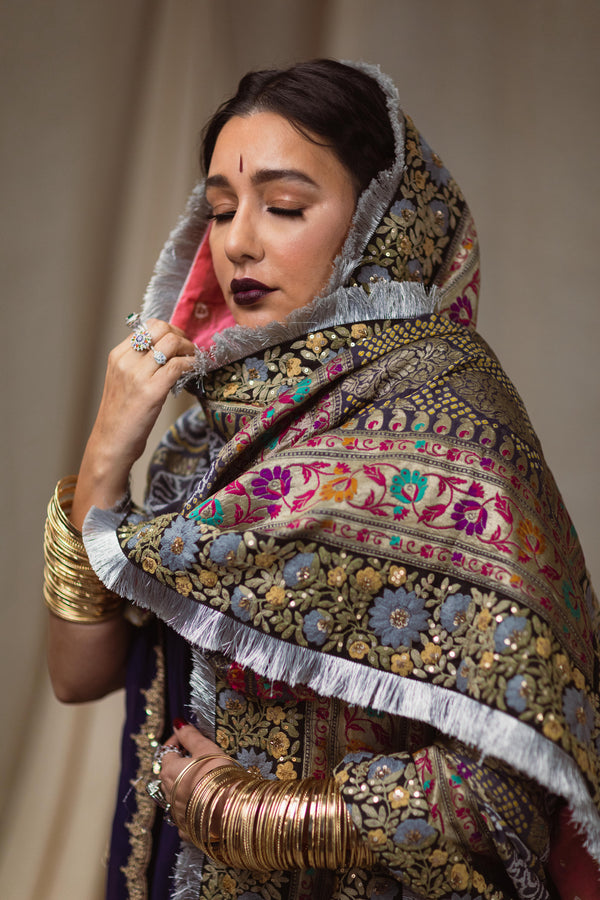 A women wearing a hand woven wedding bandhani dupatta designed by Ayush Kejriwal.