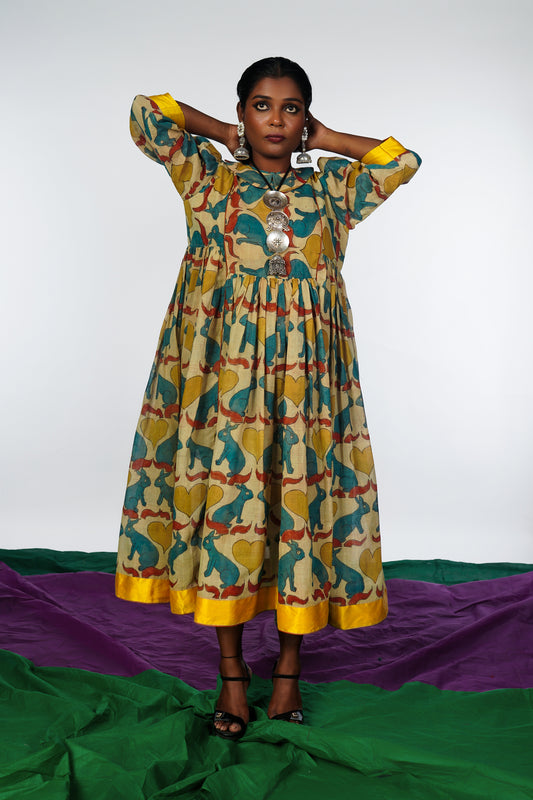 A woman wearing a hand painted pen kalamkari dress designed by Ayush Kejriwal.