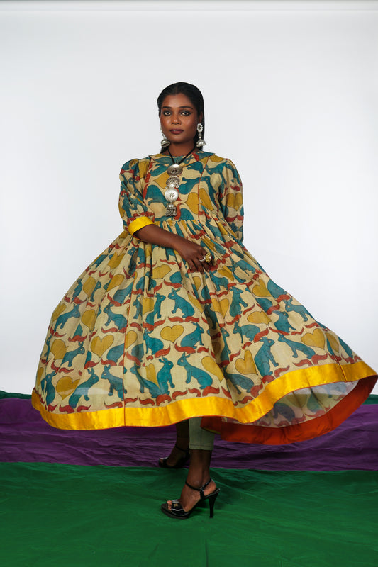 A woman wearing a hand painted pen kalamkari dress designed by Ayush Kejriwal.