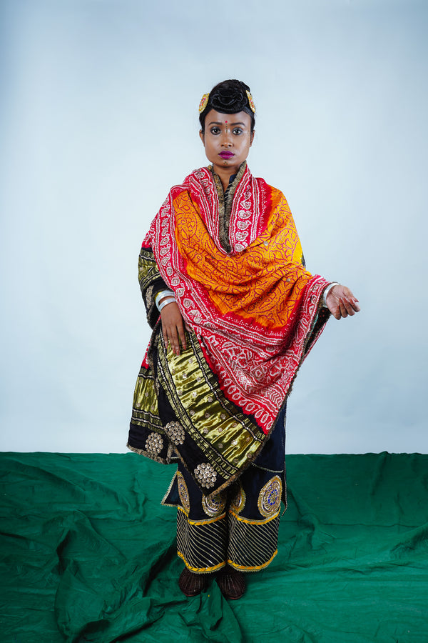 A woman wearing an Indian wedding bandhani dupatta designed by Ayush Kejriwal.