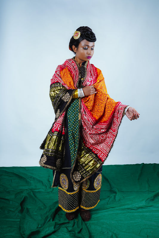 A woman wearing an Indian wedding bandhani dupatta designed by Ayush Kejriwal.