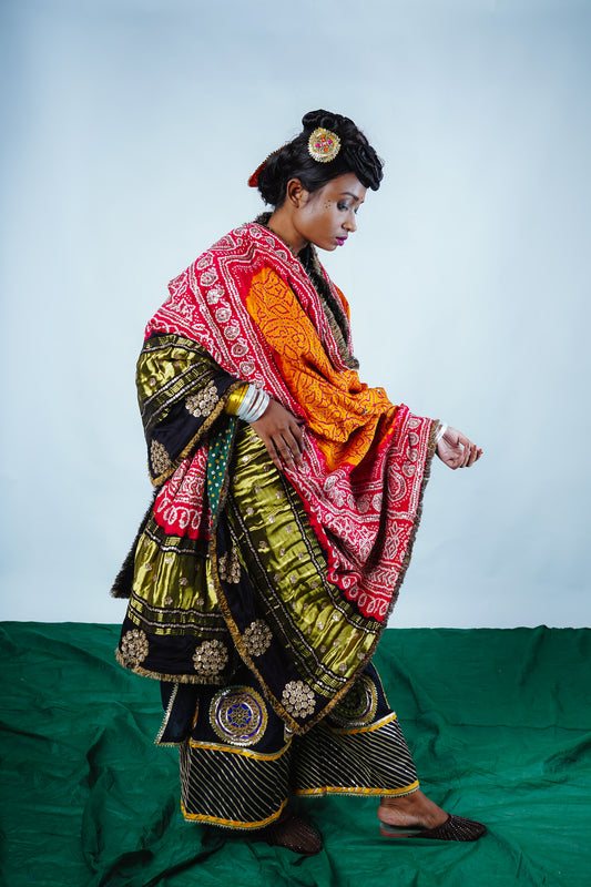 A woman wearing an Indian wedding bandhani dupatta designed by Ayush Kejriwal.