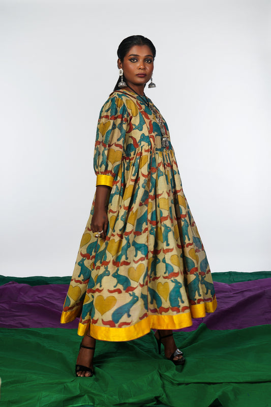 A woman wearing a hand painted pen kalamkari dress designed by Ayush Kejriwal.