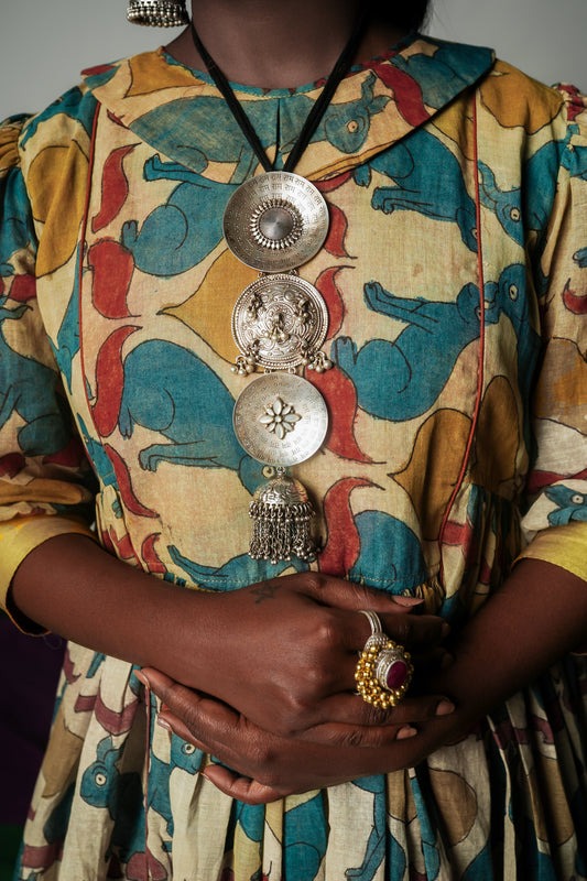 A woman wearing a hand painted pen kalamkari dress designed by Ayush Kejriwal.
