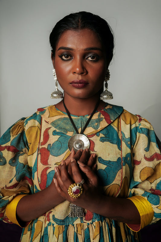 A woman wearing a hand painted pen kalamkari dress designed by Ayush Kejriwal.