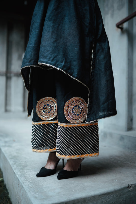 A woman wearing an Indian Ethnic Wedding Kurta and Pant (salwar kameez) set designed by Ayush Kejriwal.