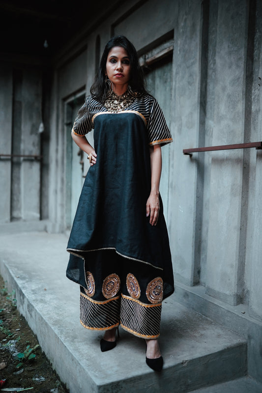 A woman wearing an Indian Ethnic Wedding Kurta and Pant (salwar kameez) set designed by Ayush Kejriwal.