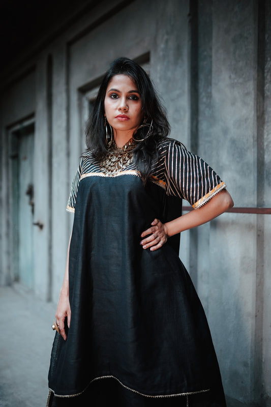 A woman wearing an Indian Ethnic Wedding Kurta and Pant (salwar kameez) set designed by Ayush Kejriwal.