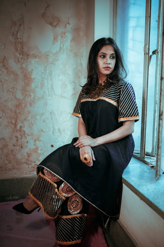 A woman wearing an Indian Ethnic Wedding Kurta and Pant (salwar kameez) set designed by Ayush Kejriwal.