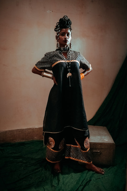 A woman wearing an Indian Ethnic Wedding Kurta and Pant (salwar kameez) set designed by Ayush Kejriwal.