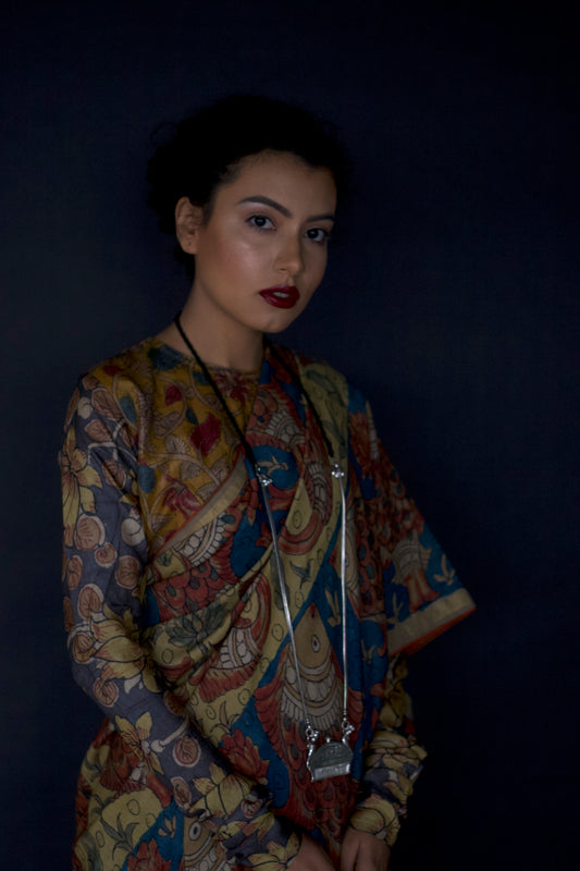 A woman wearing an authentic handmade pen Kalamkari saree designed by Ayush Kejriwal.