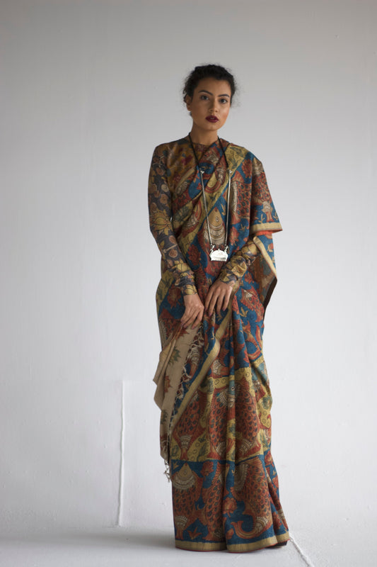 A woman wearing an authentic handmade pen Kalamkari saree designed by Ayush Kejriwal.