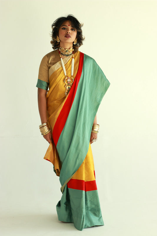 A woman wearing a handwoven gold chanderi silk saree designed by Ayush Kejriwal.