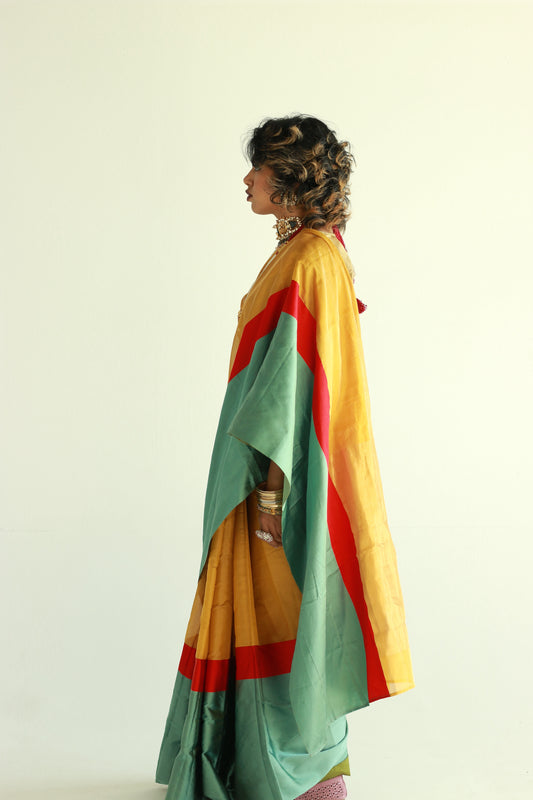 A woman wearing a handwoven gold chanderi silk saree designed by Ayush Kejriwal.