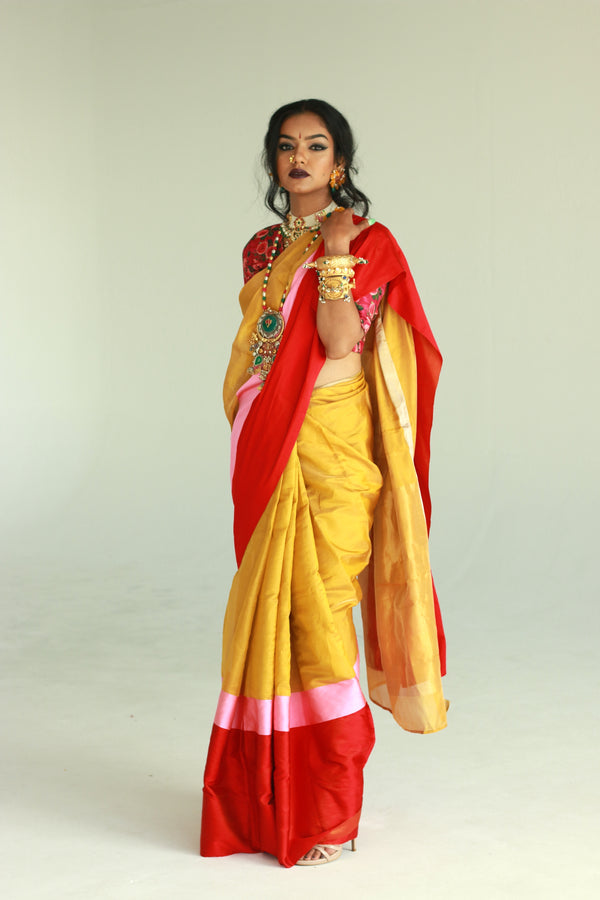 A women wearing a golden chanderi silk saree designed by Ayush Kejriwal.