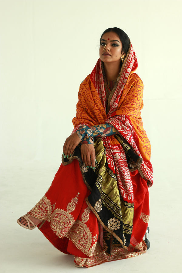 A woman wearing an Indian wedding bandhani dupatta designed by Ayush Kejriwal.