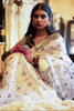 Woman in an hand embroidered organza silk saree