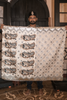 Person holding an hand embroidered organza silk saree indoors.