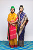 Two women wearing handwoven Cora benarsi silk sarees designed by Ayush Kejriwal.