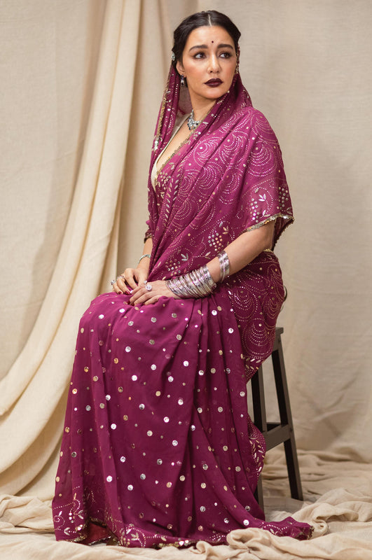 A woman wearing a hand embroidered georgette part wear saree designed by Ayush Kejriwal.