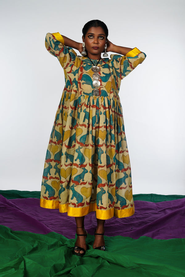 A woman wearing a hand painted pen kalamkari dress designed by Ayush Kejriwal.