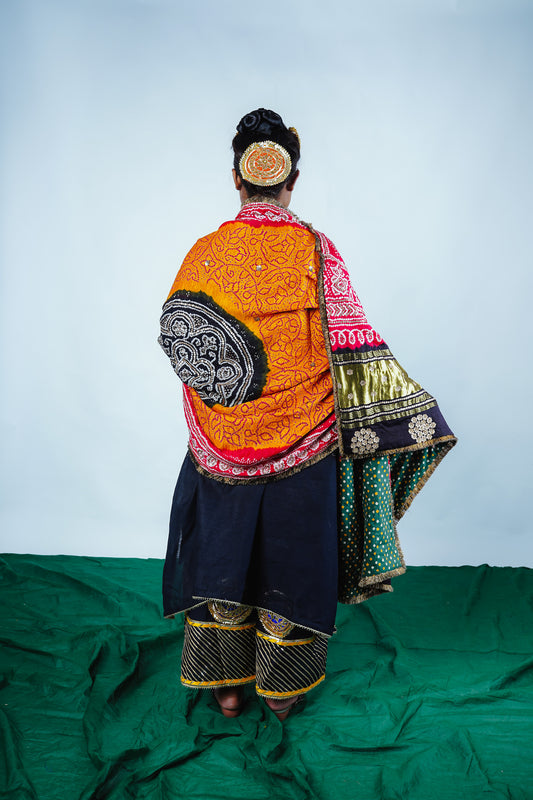 A woman wearing an Indian wedding bandhani dupatta designed by Ayush Kejriwal.
