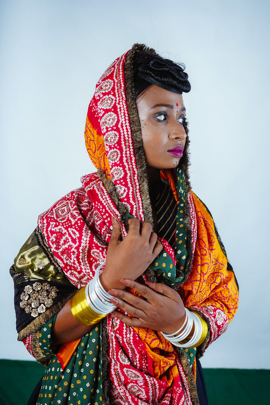 A woman wearing an Indian wedding bandhani dupatta designed by Ayush Kejriwal.