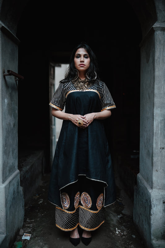 A woman wearing an Indian Ethnic Wedding Kurta and Pant (salwar kameez) set designed by Ayush Kejriwal.