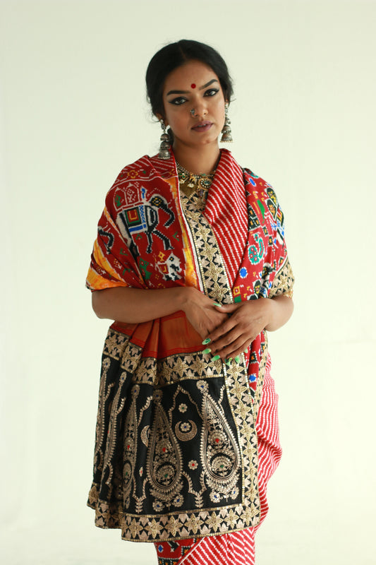 A woman showcasing a hand embroidered , handwoven patan patola silk saree designed by Ayush Kejriwal.