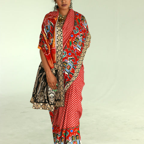 A woman showcasing a hand embroidered , handwoven patan patola silk saree designed by Ayush Kejriwal.