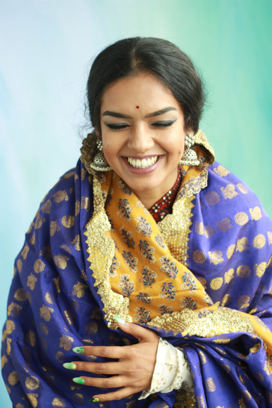 A woman wearing a handwoven embroidered kanjiveram silk dupatta designed by Ayush Kejriwal.