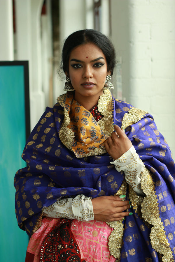 A woman wearing a handwoven embroidered kanjiveram silk dupatta designed by Ayush Kejriwal.