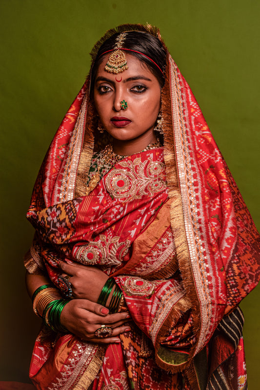 A women wearing a hand woven patola silk dupatta designed by Ayush Kejriwal.