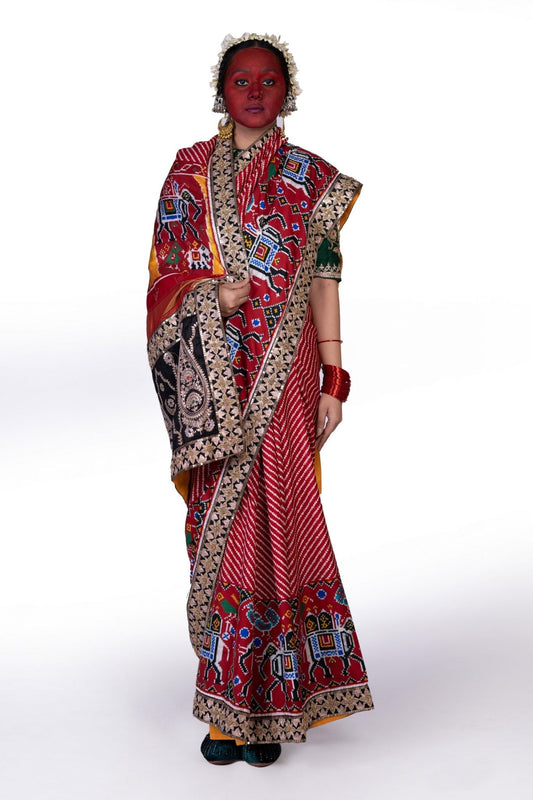 A woman wearing a handcrafted real patan patola saree designed by Ayush Kejriwal.